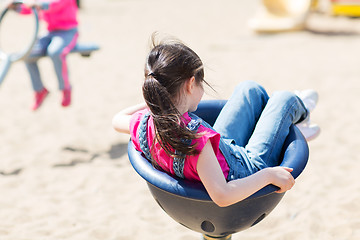 Image showing close up of girl playing on children playground