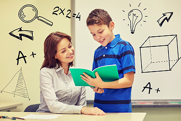 Image showing school boy with notebook and teacher in classroom