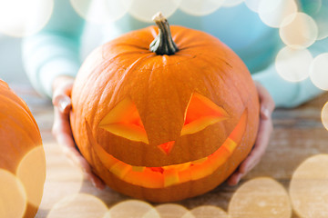 Image showing close up of woman with pumpkins at home