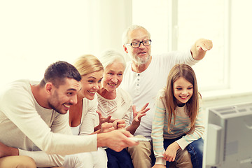 Image showing happy family watching tv at home