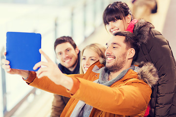 Image showing happy friends with tablet pc on skating rink