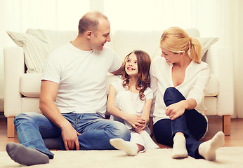 Image showing parents and little girl sitting on floor at home