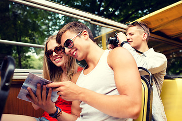 Image showing smiling couple with book traveling by tour bus