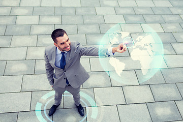 Image showing smiling businessman with globe projection outdoors