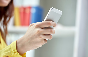 Image showing close up of female hands with smartphone at home