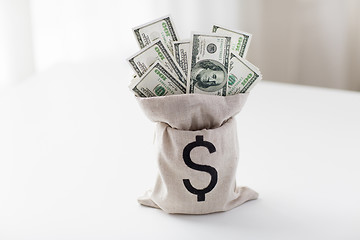 Image showing close up of dollar paper money in bag on table