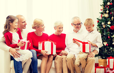 Image showing smiling family with gifts at home