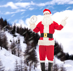 Image showing man in costume of santa claus with clock