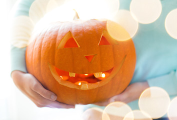 Image showing close up of woman with pumpkins at home