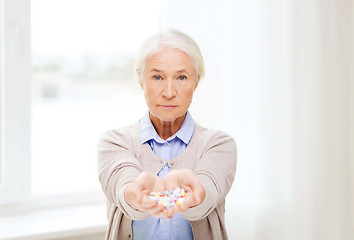 Image showing senior woman with medicine at home