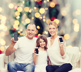 Image showing happy family with smartphones