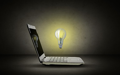 Image showing open laptop computer with lighting bulb