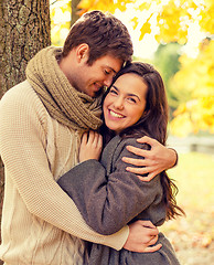 Image showing smiling couple hugging in autumn park