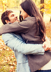 Image showing smiling couple hugging in autumn park