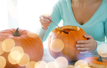 Image showing close up of woman with pumpkins at home