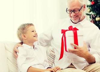 Image showing smiling grandfather and grandson at home