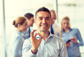 Image showing group of smiling businesspeople meeting in office