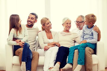 Image showing happy family sitting on couch at home