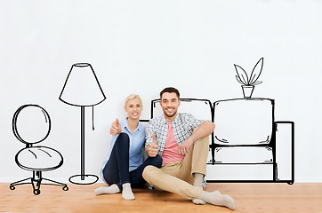 Image showing happy couple showing thumbs up at new home