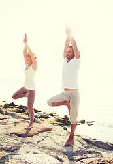 Image showing couple making yoga exercises outdoors