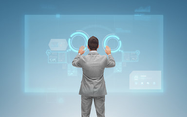 Image showing businessman working with virtual screens