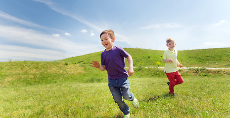 Image showing happy little boys running outdoors