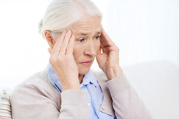 Image showing face of senior woman suffering from headache