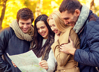 Image showing group of friends with map outdoors