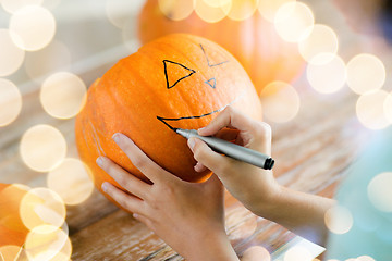 Image showing close up of woman with pumpkins at home