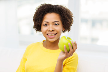 Image showing happy african american woman with green apple