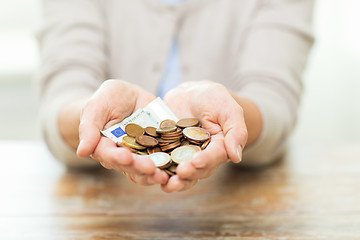 Image showing close up of senior woman hands holding money