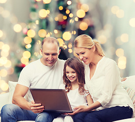 Image showing smiling family with laptop