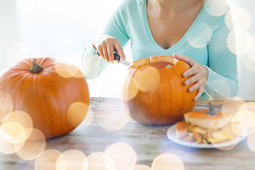 Image showing close up of woman with pumpkins at home