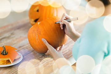 Image showing close up of woman with pumpkins at home