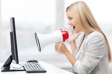 Image showing strict businesswoman shouting in megaphone