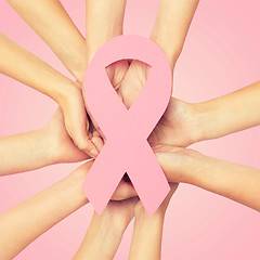 Image showing close up of hands with cancer awareness symbol