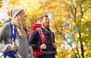 Image showing smiling couple with backpacks hiking over autumn