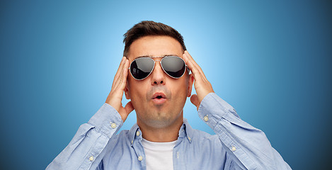 Image showing face of scared man in shirt and sunglasses