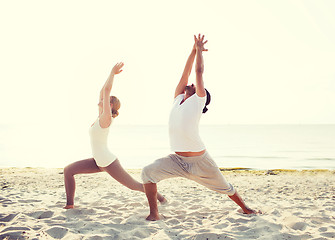 Image showing couple making yoga exercises outdoors