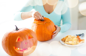 Image showing close up of woman with pumpkins at home