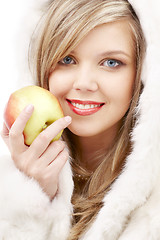 Image showing lovely blond in fur with apple