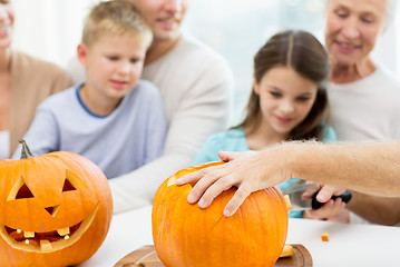 Image showing family making lantern of pumpkins for helloween