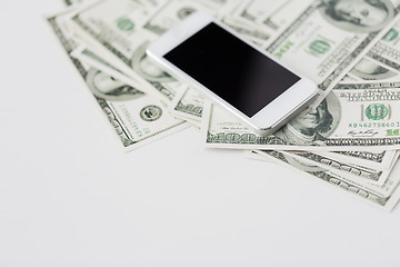 Image showing close up of smartphone and dollar money