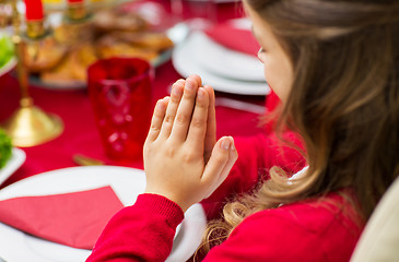 Image showing close up of girl praying at christmas dinner