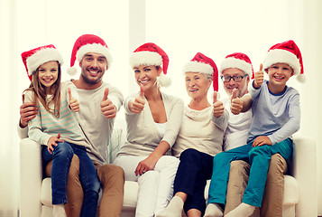 Image showing happy family sitting on couch at home