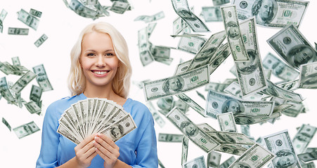 Image showing smiling businesswoman with dollar cash money