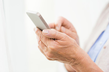 Image showing close up of senior woman with smartphone texting