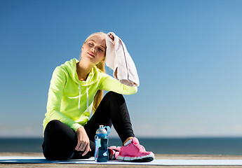 Image showing woman resting after doing sports outdoors