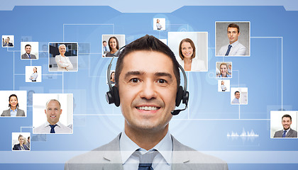 Image showing businessman in headset over contacts icons