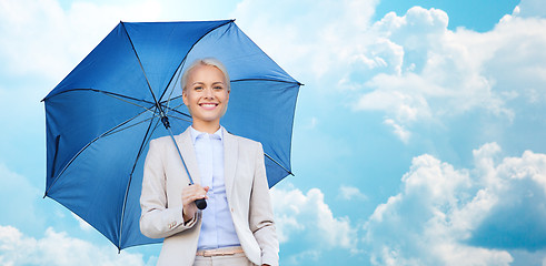 Image showing young smiling businesswoman with umbrella outdoors